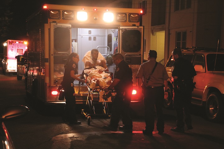 One of the victims of a shooting in South Ozone Park early on August 11 is being loaded into an ambulance.