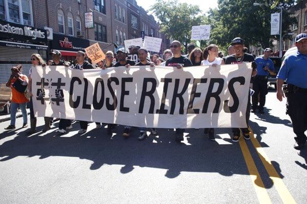 Nearly a thousand protesters march through Astoria calling for close of Rikers Island