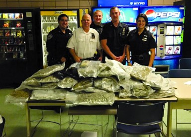 Members of the 112th Precinct with the stash of marijuana they found at a Rego Park apartment on Oct. 22.