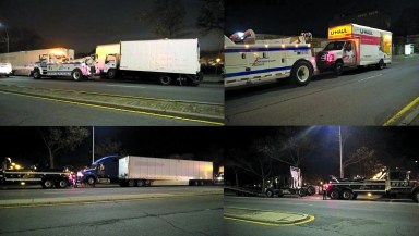 The NYPD's heavy tow truck was busy removing illegally parked trucks in the 102nd Precinct on Tuesday night, Nov. 15.