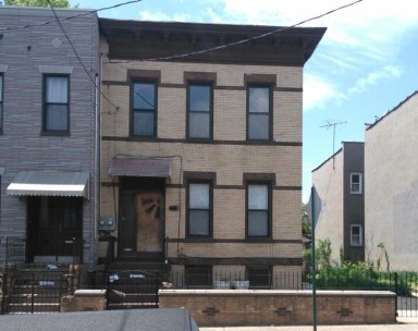 A modern townhouse will be built adjacent to this pre-war home on 60th Street in Ridgewood.