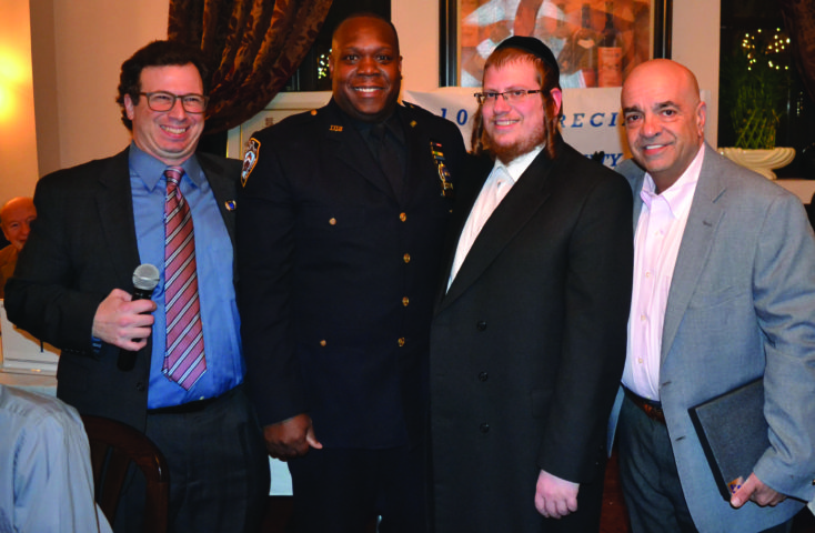 Detective Thomas Bell (second from left) was honored as the 104th Precinct's Cop of the Year. He's pictured with (from left to right) Len Santoro, 104th Precinct Community Council president; Abraham Markowitz, the council's vice president; and Joe Aiello, president of the Kiwanis Club of Glendale.
