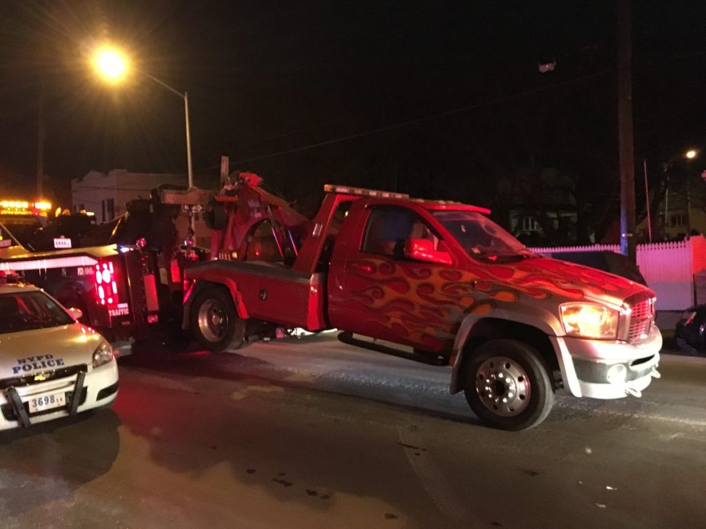 A tow truck is towed away during an illegal parking crackdown conducted by the 104th Precinct in Maspeth on Feb. 2-3, 2017