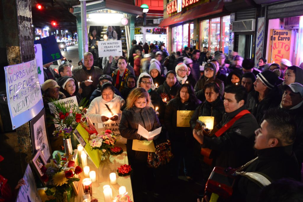 Residents gather at a candlelight vigil and rally on Feb. 21 in honor of the late Corona street vendor Claudia Lopez.