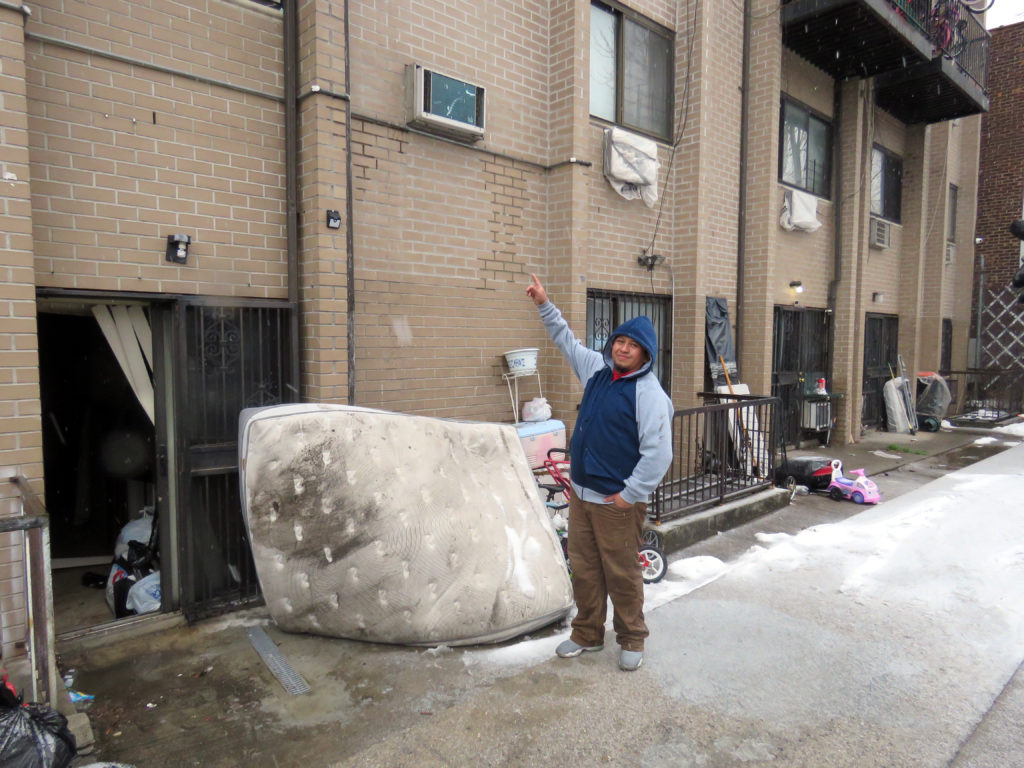Building super Roberto Flores points to where children jumped from the second floor at 56-14 Waldron st. in corona Queens ,he used the mattress to save the kids along with the pets had to jump from the second floor and were caught by the building super Roberto Flores. Photos by Robert Stridiron. 02/12/17