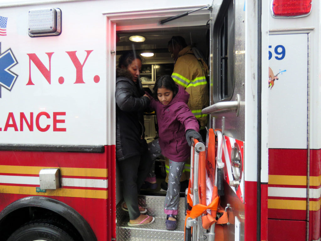 Mother Ramonita Rosa helps Gianna Rosa age 10 after being checked by ems at the fire located 56-14 Waldron st. in corona Queens , the kids alond with the pets had to jump from the second floor and were caught by the building super Roberto Flores. Photos by Robert Stridiron. 02/12/17