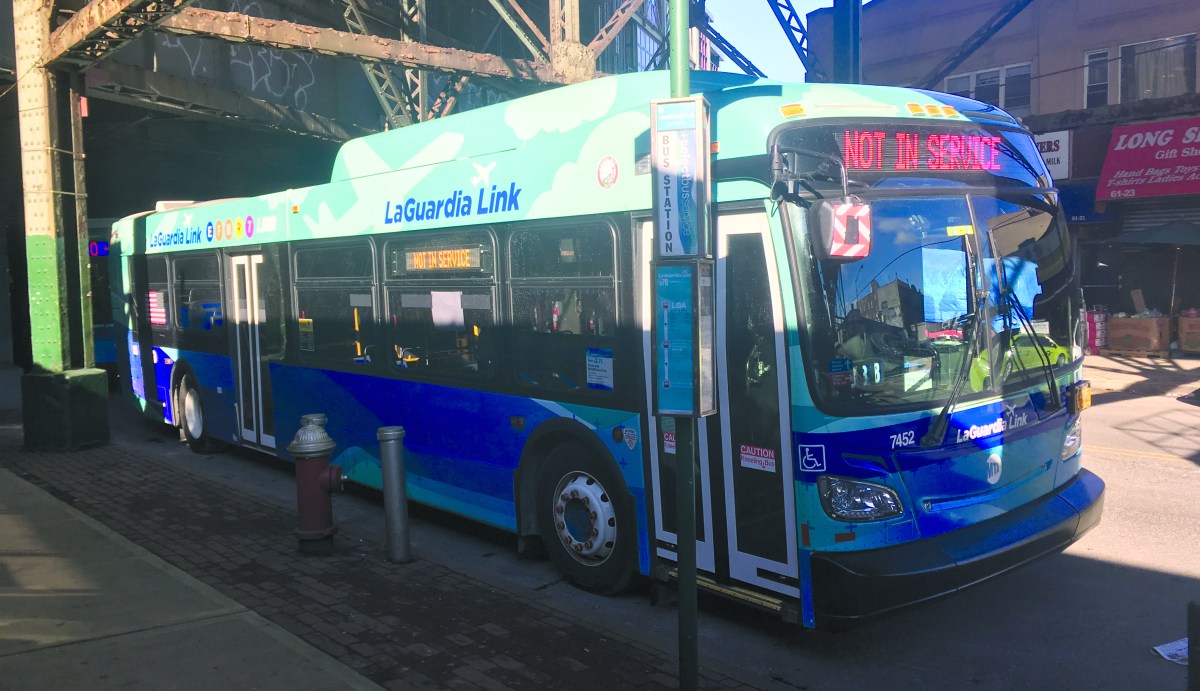 An out-of-service LaGuardia Link bus parked on Roosevelt Avenue near 61st Street in Woodside.