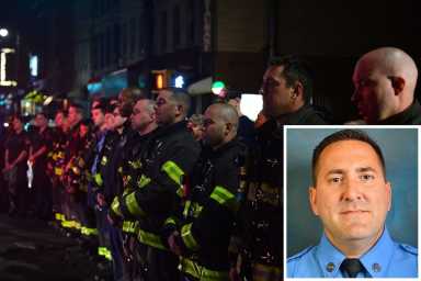Firefighters outside Wyckoff Heights Medical Center on Thursday night as the body of Firefighter William Tolley is transferred.