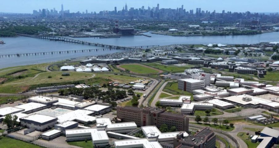 Some of the prisons on Rikers Island, with Queens and the Manhattan skyline in the background.