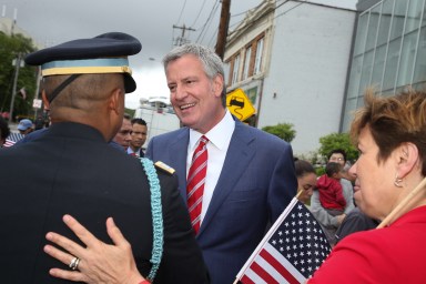 Mayor Bill de Blasio, shown at the 2017 Little Neck-Douglaston Memorial Day Parade, is loved or hated in Queens depending on who you ask, according to a recent poll.
