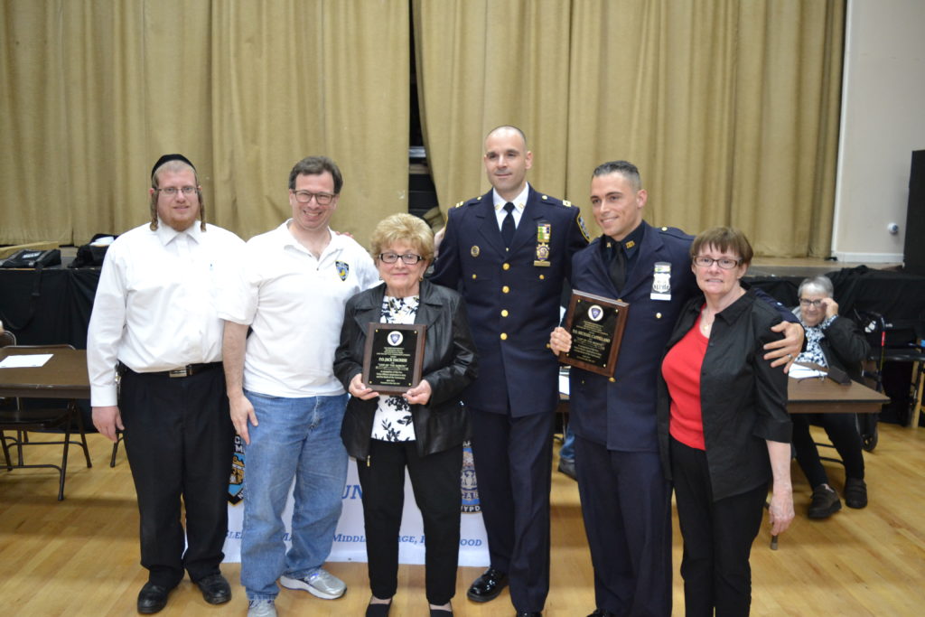 P.O. Michael Cappellano with his family, Captain John Mastronardi at the May 16 104th Precinct Community Council meeting. Also show at left are Abraham Markowitz and Len Santoro of the 104th Precinct Community Council. (photo: Robert Pozarycki/QNS)