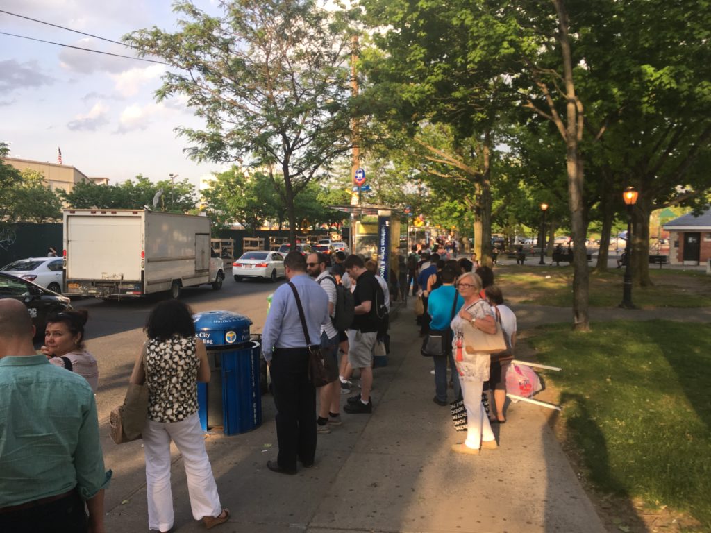 This photo, taken at 6:50 p.m. on May 19, shows lines of commuters waiting for the Q29 and Q38 buses at stop on Hoffman Drive near Woodhaven Boulevard in Elmhurst. (photo by Robert Pozarycki)