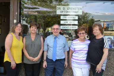 Dr. David Orenstein (center) has served the Queens community for 30 years.