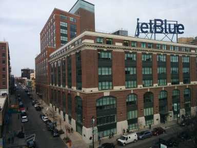 1200px-Brewster_Building_from_Queensboro_Plaza_Platform