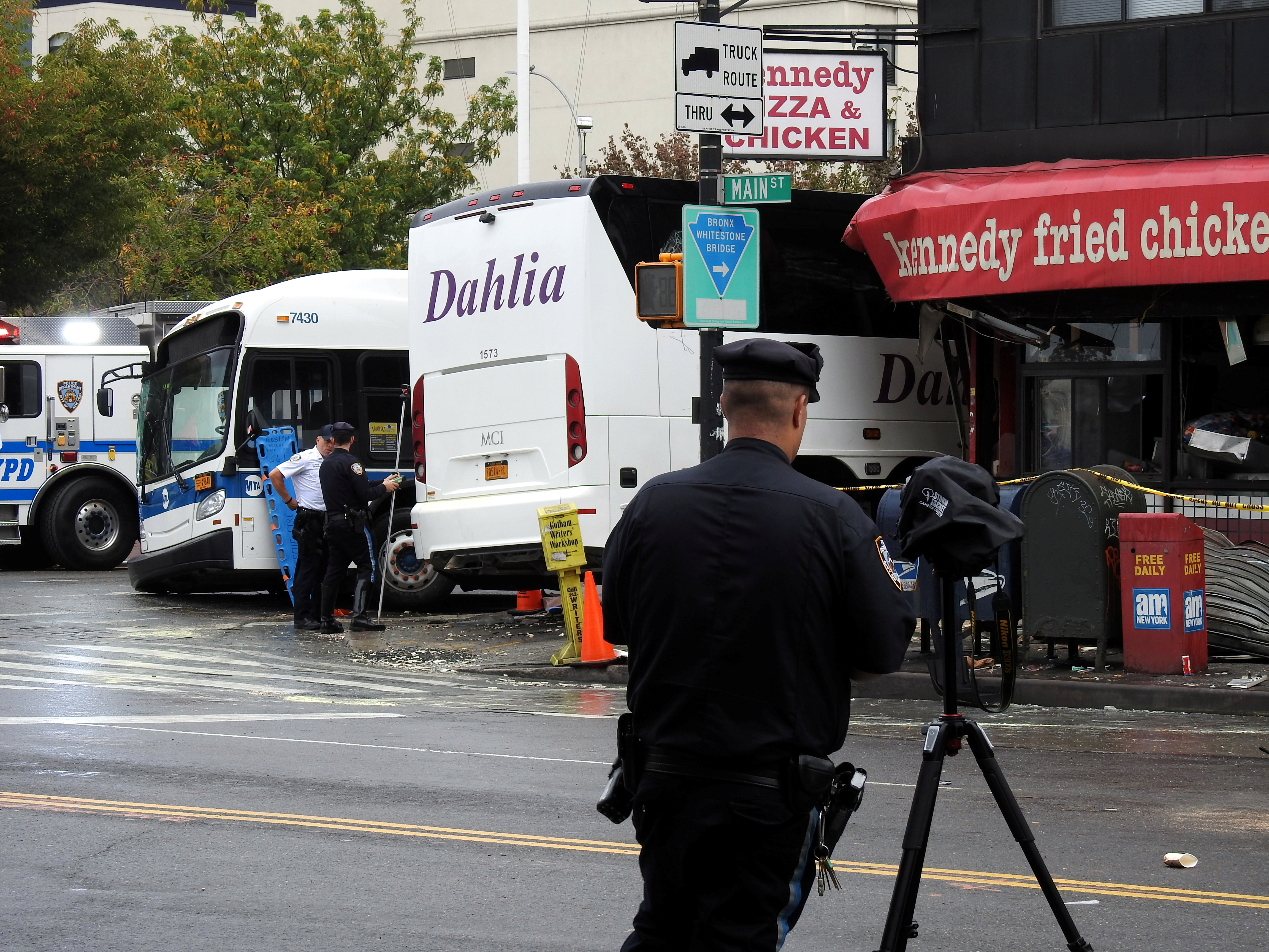 A police officer stands near the site of a deadly bus accident in Flushing on Sept. 18.