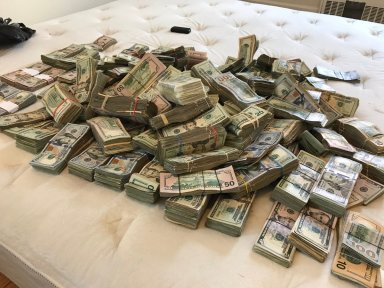 This large pile of cash was found inside a Saunders Street apartment in Rego Park on Sept. 1 where seven police officers were exposed to a foreign chemical.