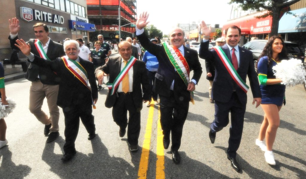 Parade grand marshal Rocco Commisso and other dignitaries greet spectators at the Astoria Columbus Day Parade on Oct. 7.