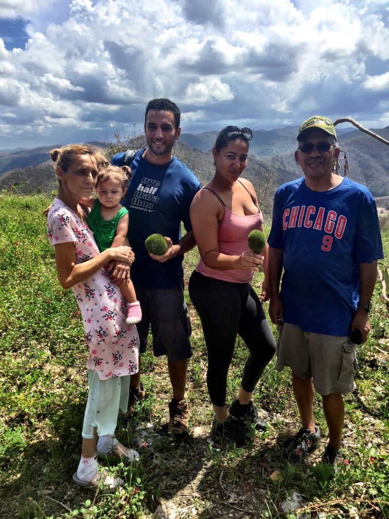 Bucella (middle) and Glenda (second from right) and Matias with a family in Utuado. 