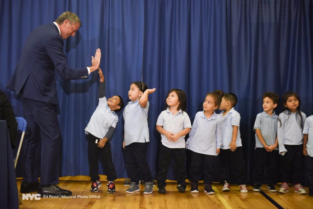 Mayor Bill de Blasio gave out high-fives to kids in Ozone Park on Oct. 12.