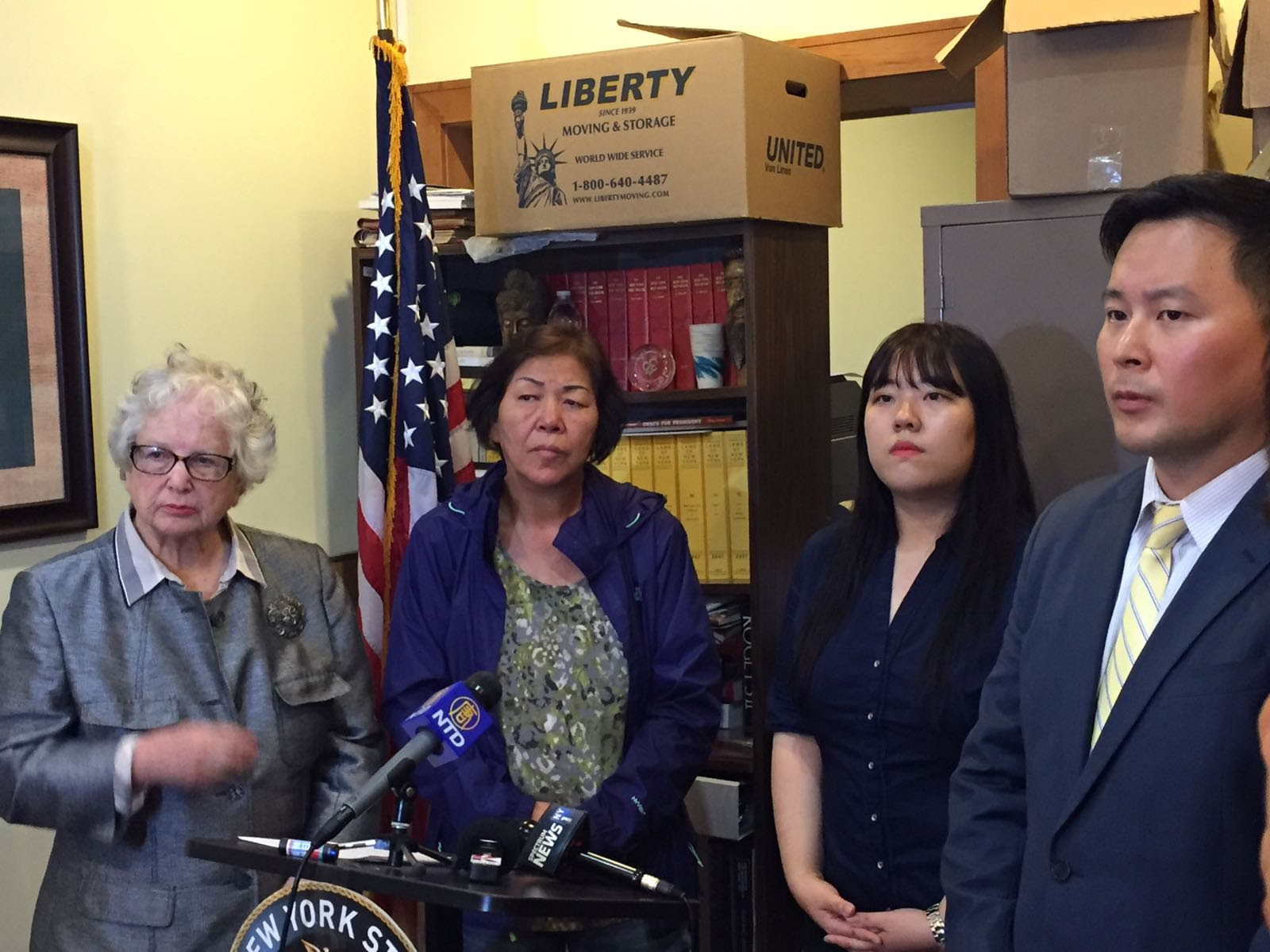 Assemblymember Ron Kim and state Senator Toby Ann Stavisky stand with Young Lim, wife of crash victim SangKi Kang