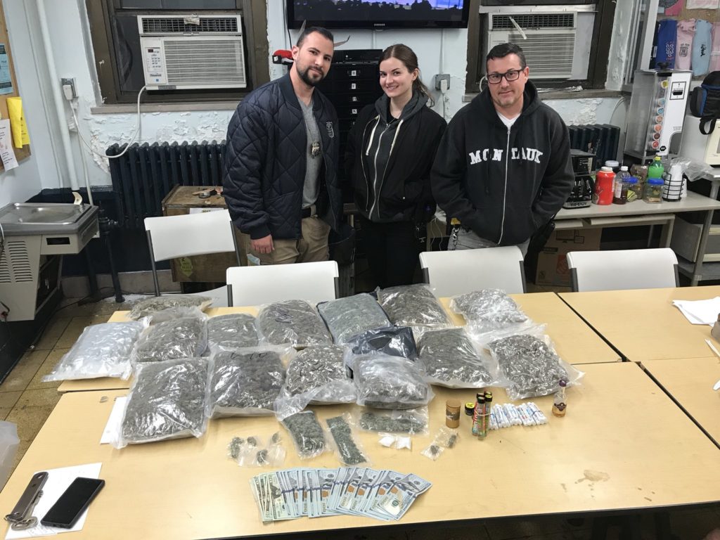 Members of the 110th Precinct Anti-Crime Unit are pictured with the proceeds of a successful drug bust on Nov. 28.