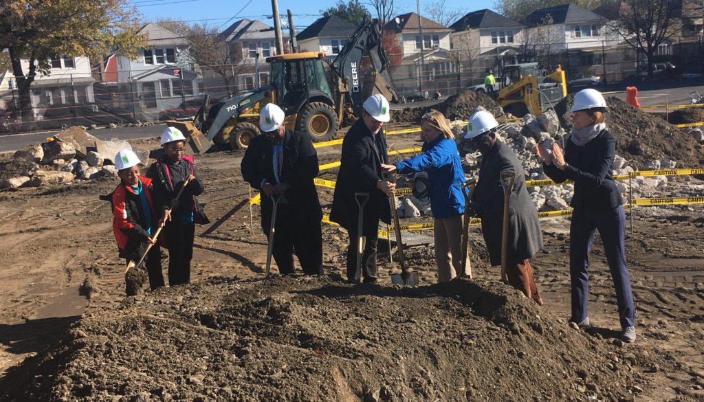City officials dig into the site of a new playground in Jamaica on Nov. 17.