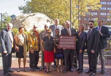 Two East Elmhurst hotels rededicate giant boulder at behest of community elders