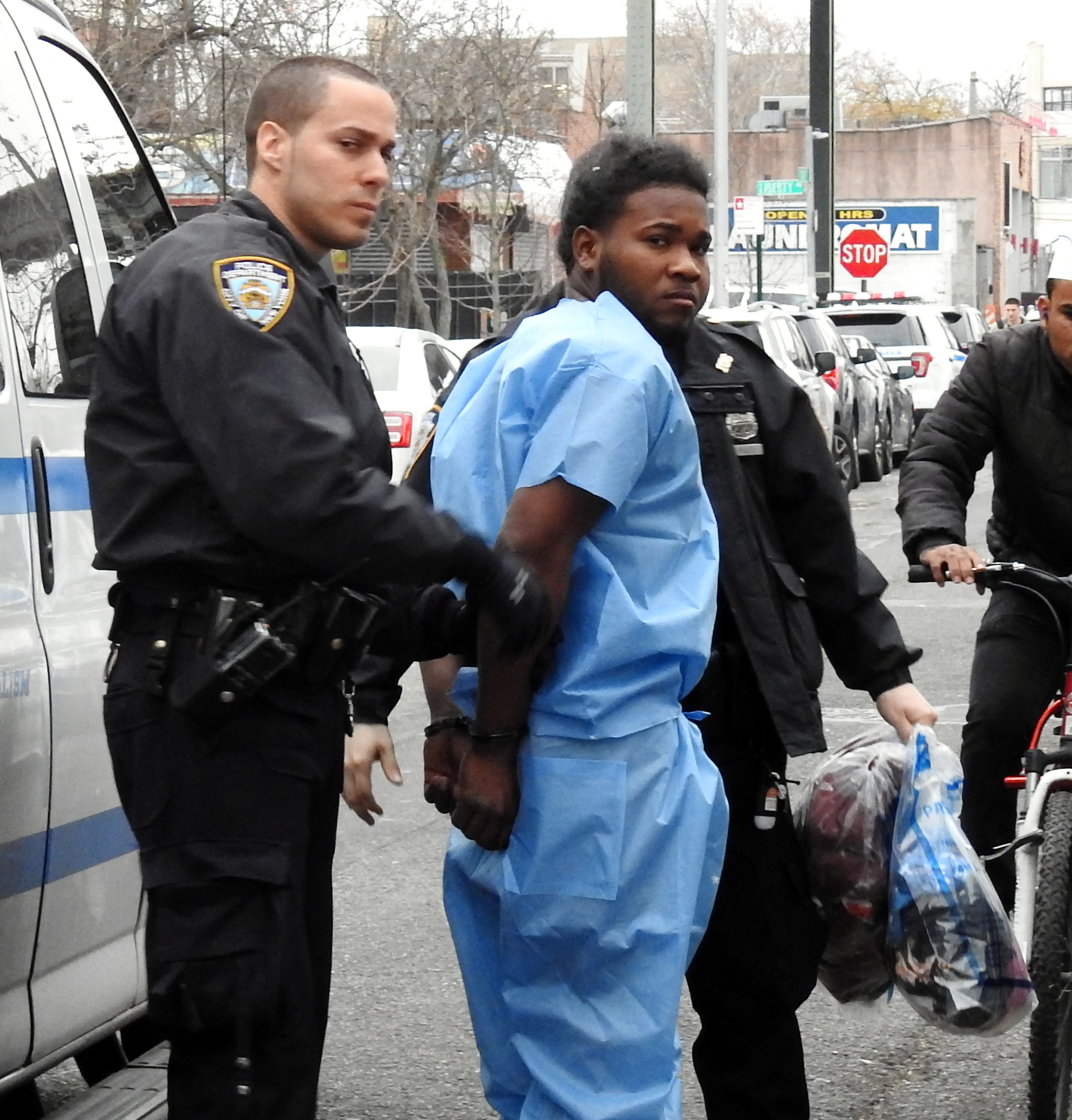 The suspect in Sunday's wild hit-and-run outside a Richmond Hill hookah lounge is brought to the 106th Precinct stationhouse in Ozone Park for questioning on Dec. 3.