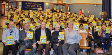 Dromm, civic association distribute Jackson Heights history books to students at PS 69