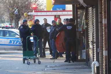 Police officers gathered outside an apartment building in Glendale during a Jan. 13 standoff.