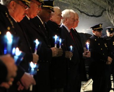 Police officials lead a vigil in honor of Police Officer Edward Byrne in Jamaica on Feb. 26.