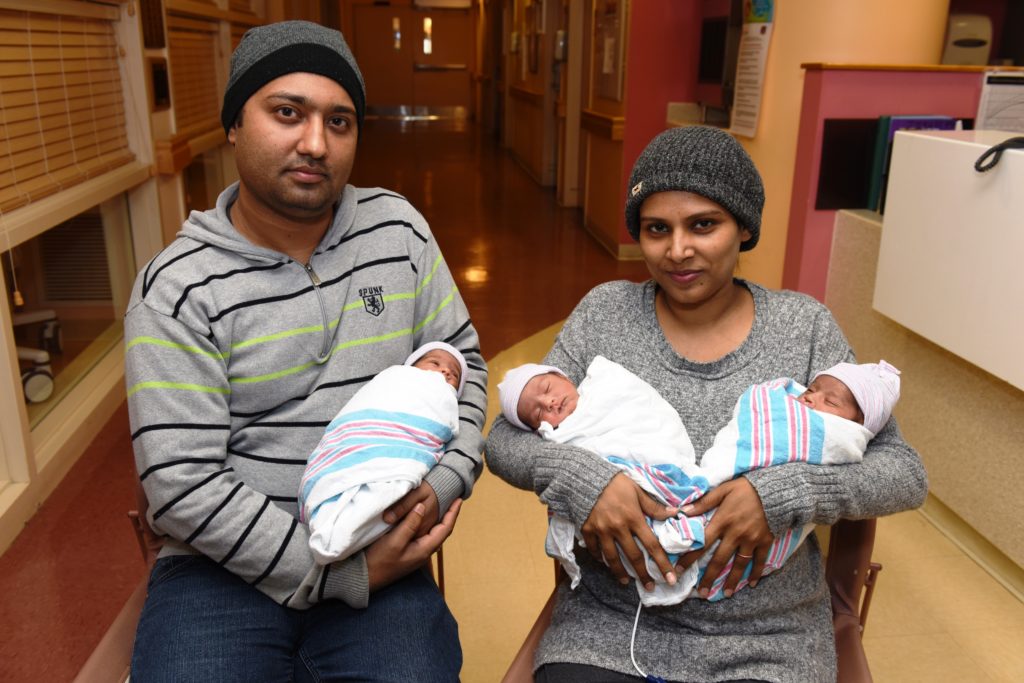 Proud parents of baby triplets Manjinder Singh and Navdeep Kaur cradle their newborn daughters while still at NYC Health + Hospitals/Queens, where the babies were delivered. The triplets were transferred to the NICU for several weeks until they were healthy enough to be discharged.