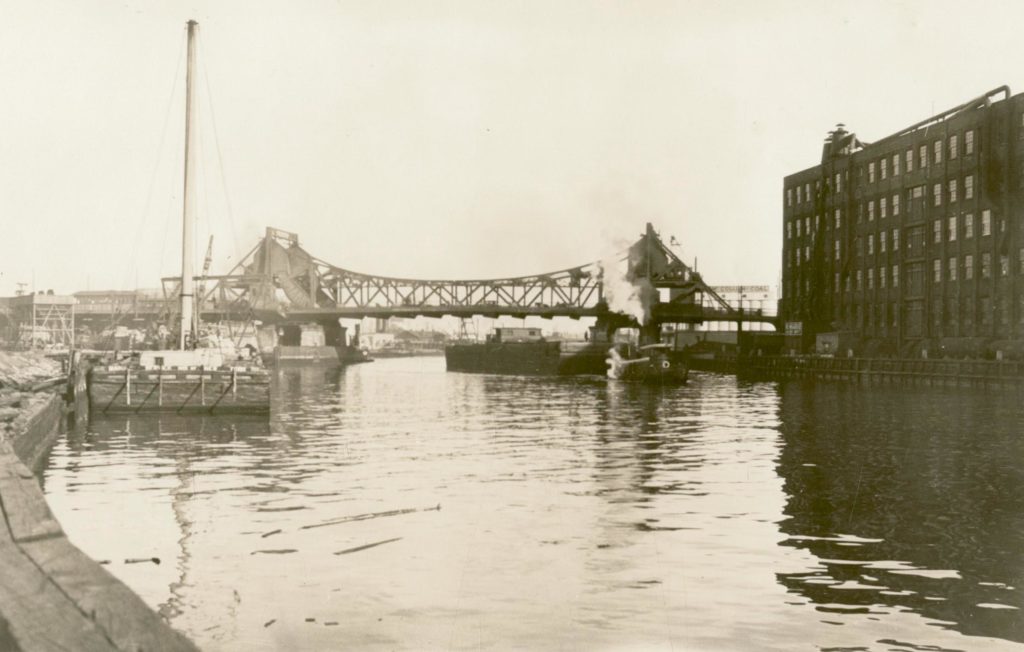 The Vernon Avenue Bridge, shown in this 1930 photo, once spanned the Newtown Creek, connecting Vernon Avenue (present-day Vernon Boulevard) in Long Island City with Manhattan Avenue in Greenpoint, Brooklyn. The bridge was later torn down and replaced by the Pulaski Bridge. (Courtesy of the Queens Borough Public Library, Archives, Eugene L. Armbruster Photographs)