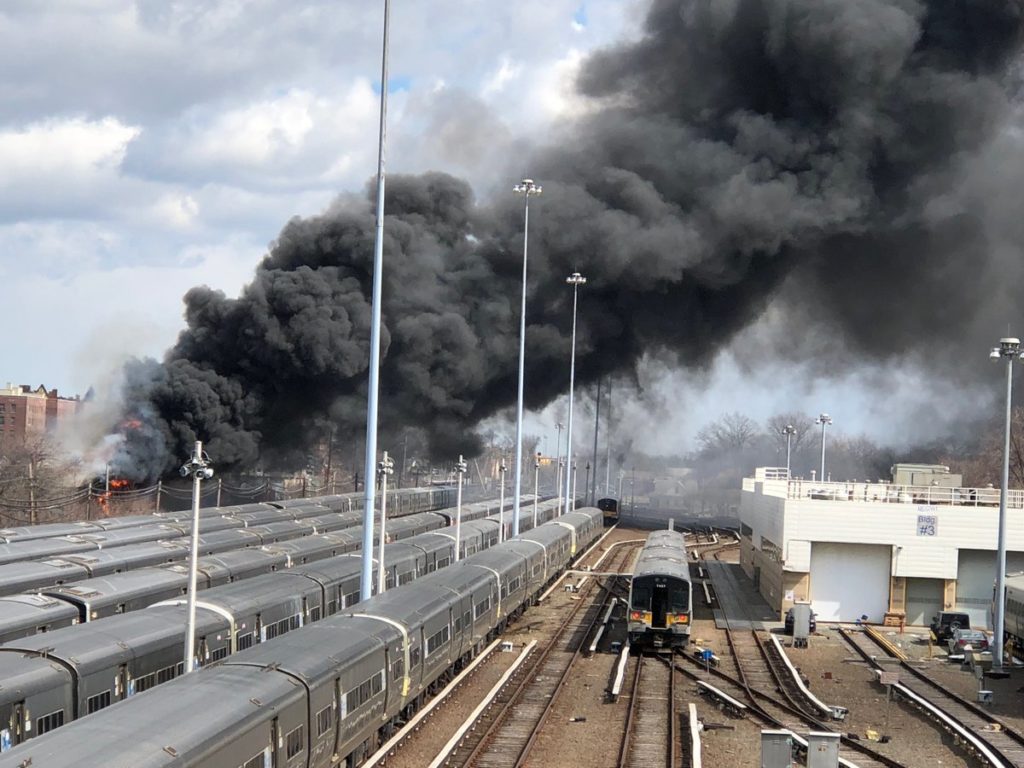 The plume of smoke rising above the LIRR Main Line near the Hillside Support Facility in Jamaica. (photo via Twitter/@LIRR)