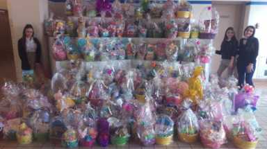 Students from two Queens schools pack Easter baskets for children in homeless shelters