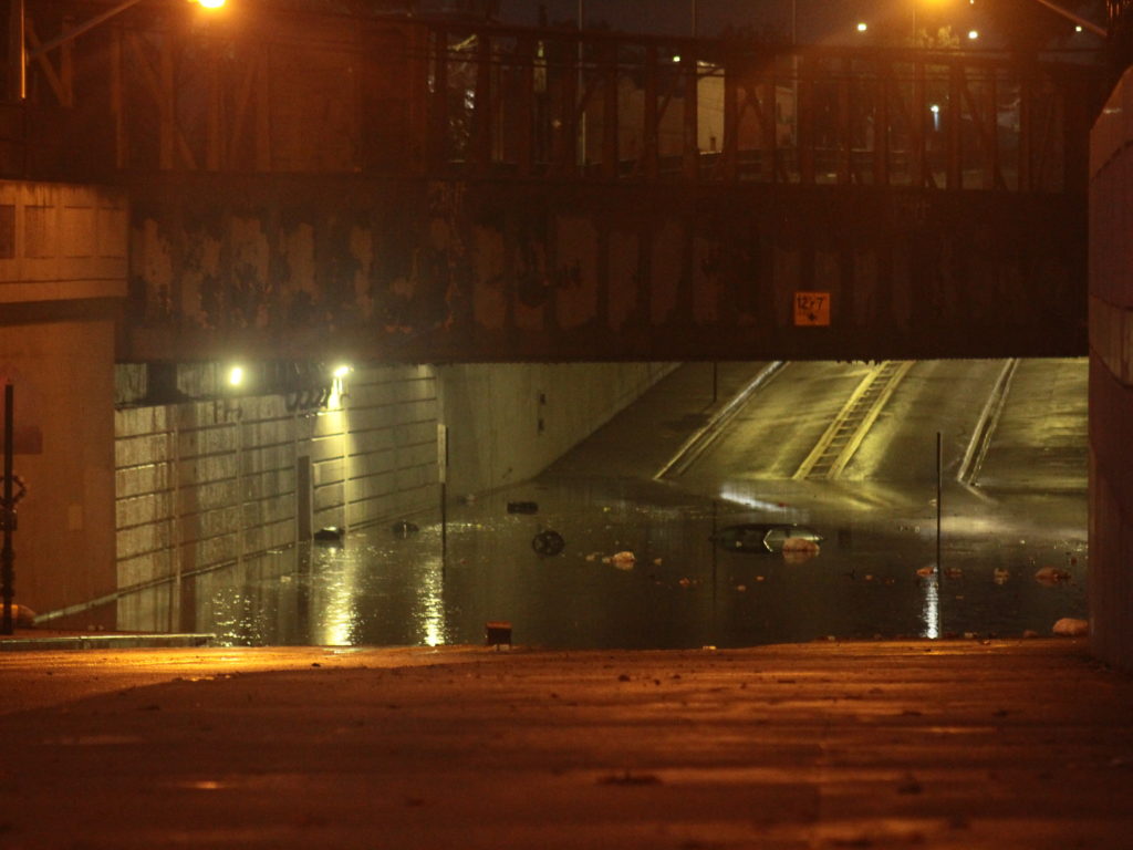 The flooding beneath the Cooper Avenue underpass after the Aug. 7 storm, with the top of a submerged vehicle visible (Photo: Matthew Whittington)