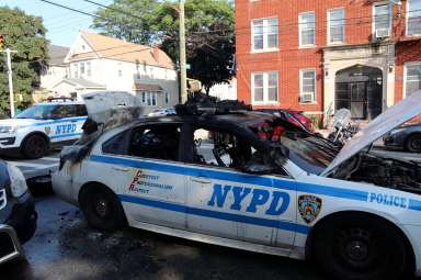 The charred remains of an NYPD patrol car that caught fire in Richmond Hill on Aug. 24.