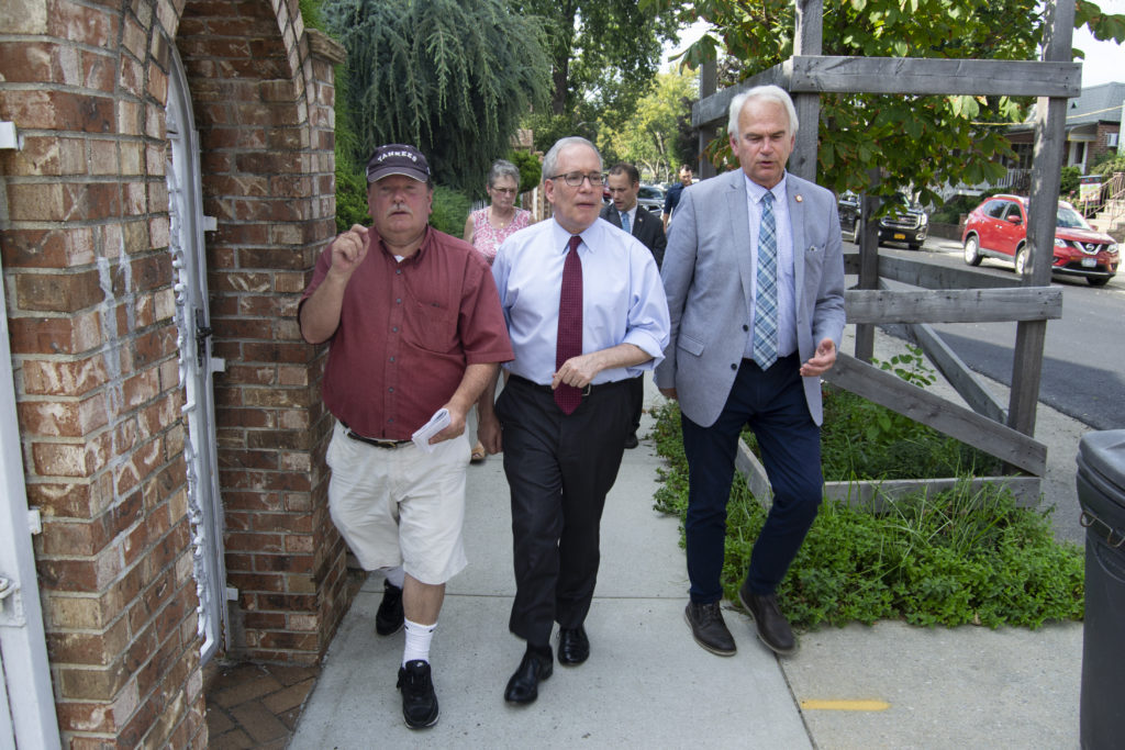 Stringer, Holden and Barnwell walk along 74th Street as residents point out the damage caused by construction and flooding (Photo: Ryan Kelley/QNS)