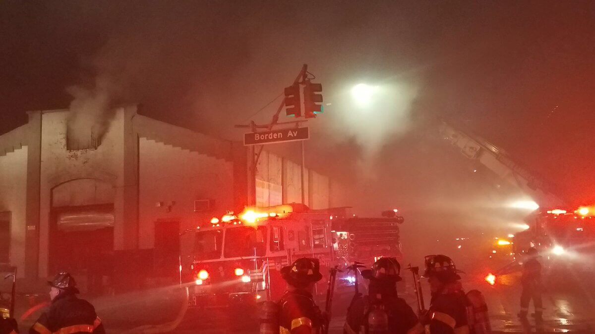Heavy smoke emanated from a Long Island City auto body shop during a four-alarm fire on Sept. 29.