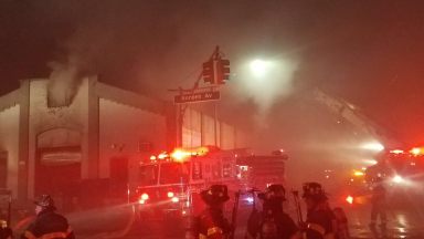 Heavy smoke emanated from a Long Island City auto body shop during a four-alarm fire on Sept. 29.