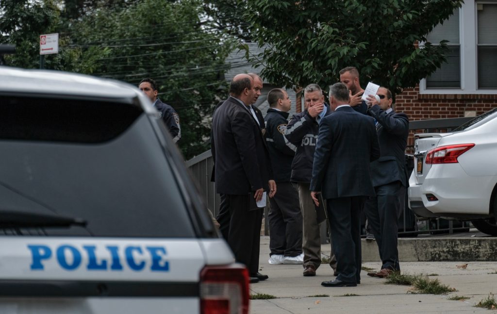 Detectives at the scene of a double homicide in East Elmhurst on Sept. 21.
