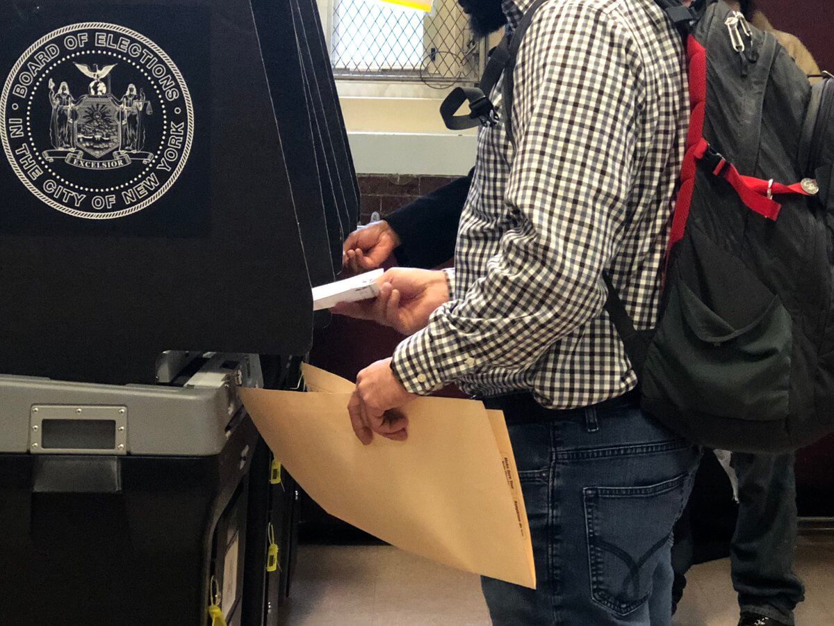 Voters inserting their ballots into scanners on Election Day 2018.