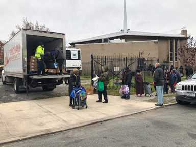 Families receive free Thanksgiving turkeys at Jamaica event