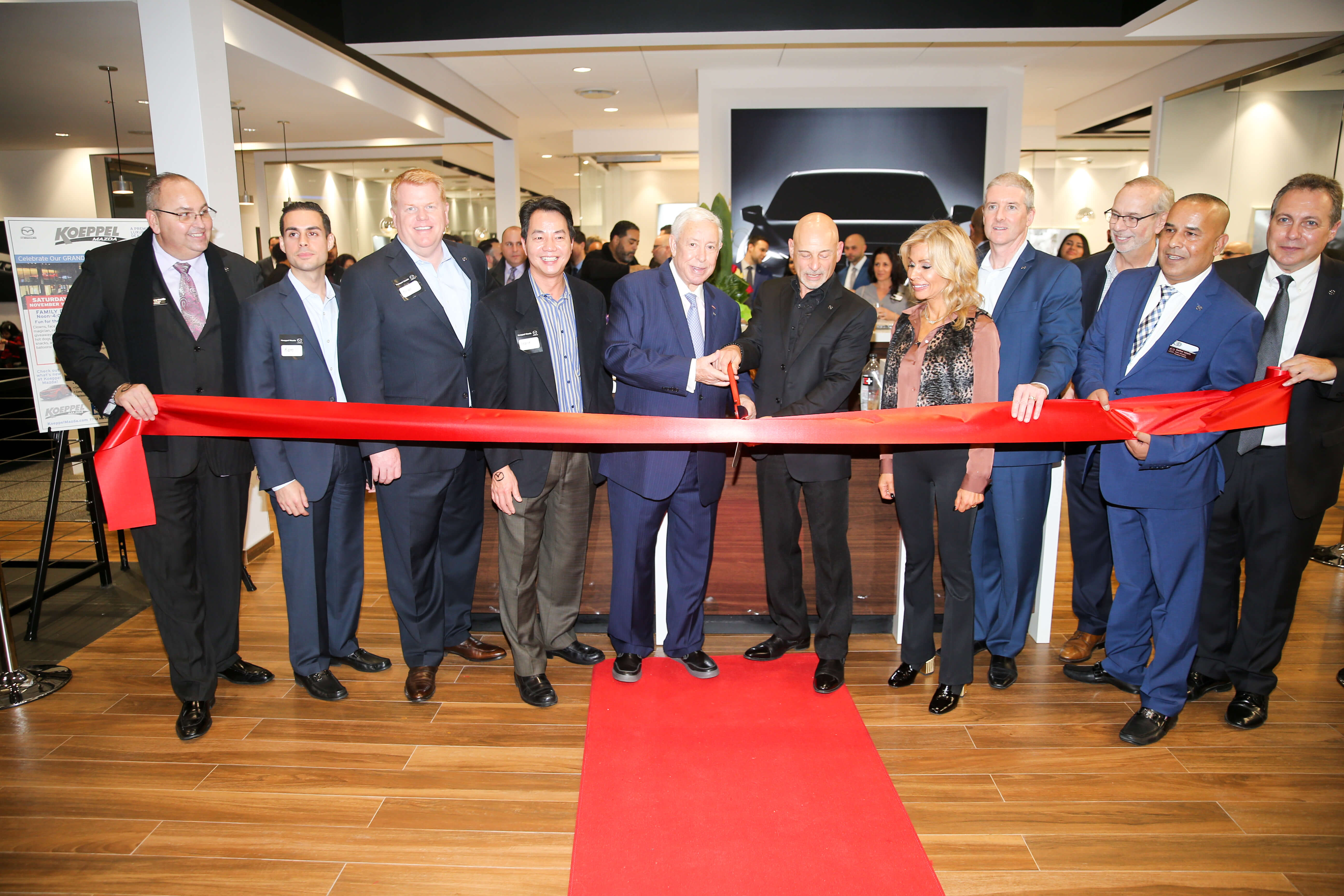 Howard Koeppel and Mark Lacher helped cut the ribbon on the new Koeppel Mazda in Jackson Heights.