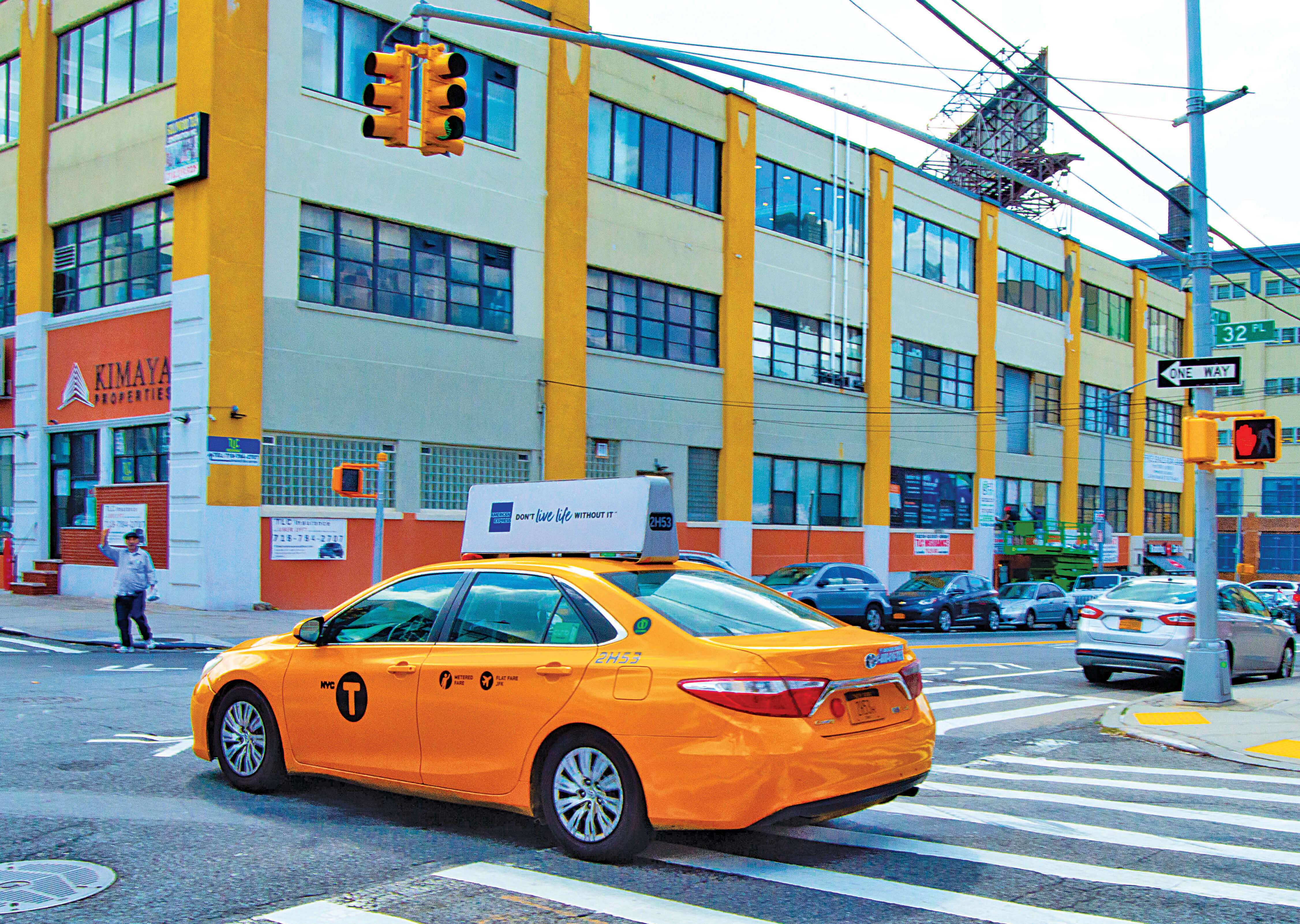 A yellow cab traveling through Queens