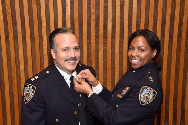 Assistant Chief Juanita Holmes places the commander pin on Assistant Chief Martin Morales, the new head of NYPD Patrol Borough Queens North