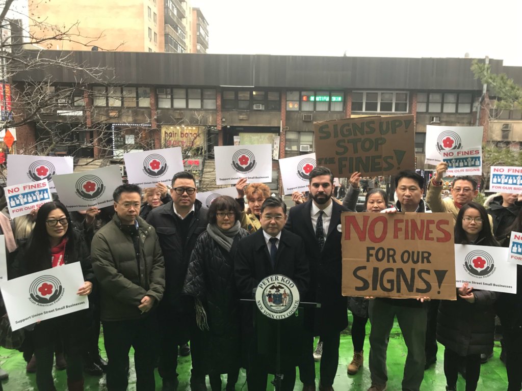 City Councilmen Rafael Espinal and Peter Koo rally with local businesses at Union Street -- the once vibrant commercial strip in Flushing now barren due to sign penalties.