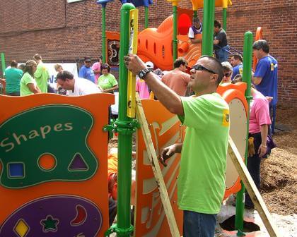 Volunteers build child play area in Howard Bch.