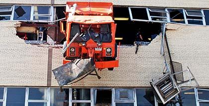 Sanitation driver’s truck plows into Maspeth garage