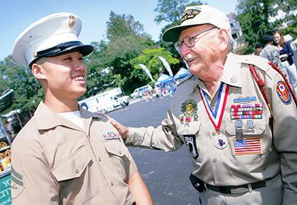 Marine Corporal Albert Chow (l.) of Woodside jokes with WWII veteran Barnet Schulman of Bayside after the Little Neck-Douglaston Memorial Day Parade. Photo by Christina Santucci